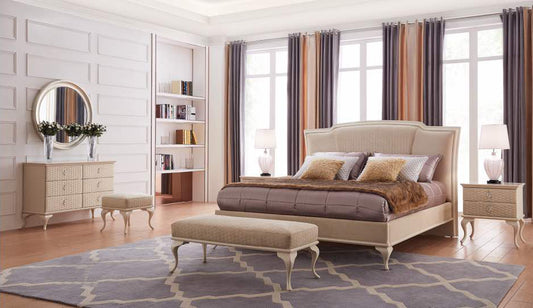 A bedroom suite consisting of a bed with a headboard and footboard, a dresser with a mirror, and a nightstand, all in beige color.