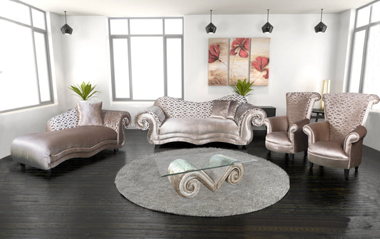 A lounge suite consisting of a sofa, loveseat, and armchairs with patterned upholstery in a room with dark flooring and wall art.