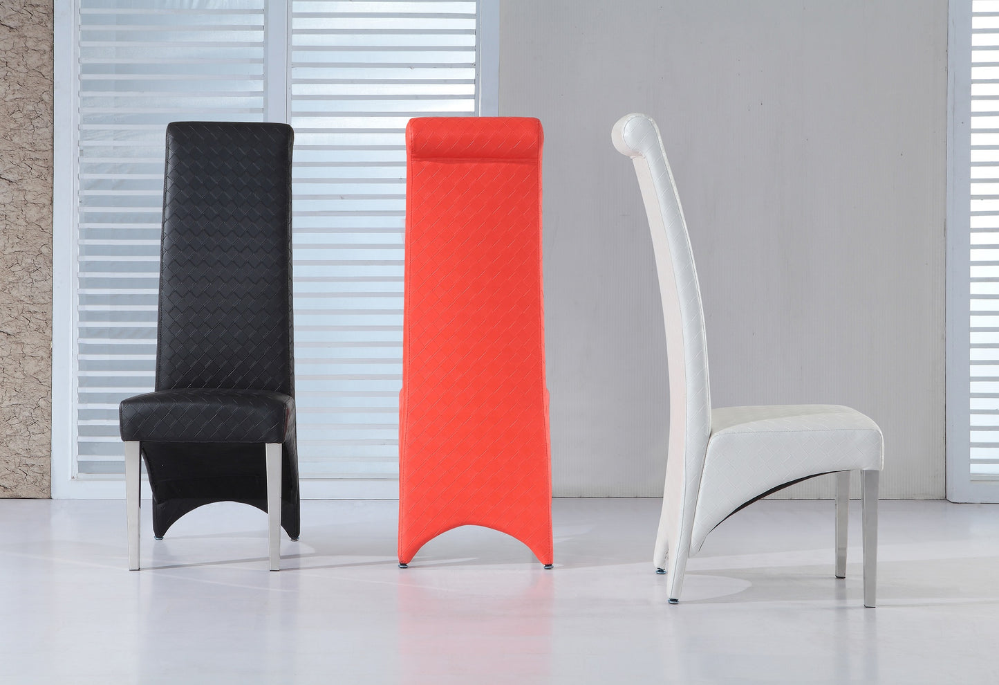 Three modern dining chairs in black, red, and white colors, positioned against a window with white vertical blinds.
