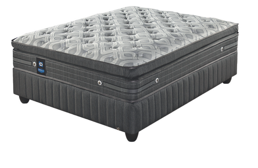 A queen-sized mattress with a pillow top, featuring a patterned design, set on a sturdy base.
