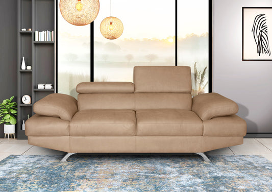 Beige sofa in a modern living room with large windows and decorative elements.